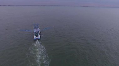 Atlantik Okyanusu 'nda açık sularda yüzen bir karides teknesinin hava üssü martılar etrafta uçarken ağlarını sürüklüyor..