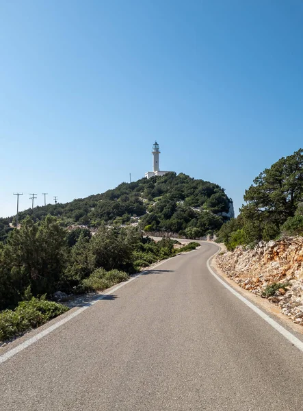 stock image A road leading to a lighthouse in the distance.