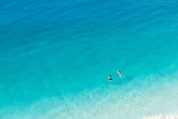 stock image Beautiful crystal clear sea water with a couple enjoying a swim