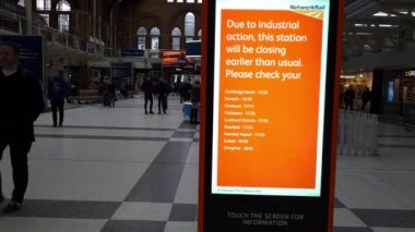 London. UK-01.04.2023. A notice in Liverpool Street train station informing passengers that the station will close early due to rail worker strike, industrial action.