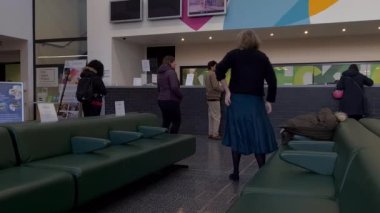 London. UK-01.13.2023. Interior view of the reception area of a NHS health centre with patients waiting for their appointments.