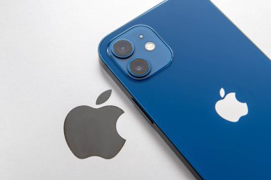 London. UK- 01.29.2023. The Apple company icon on the back of a MacBook with a iPhone on top.