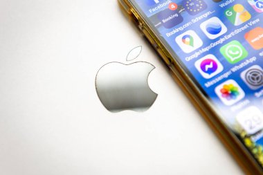 London. UK- 01.29.2023. The Apple company icon on the back of a MacBook with a iPhone on top.