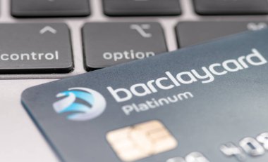 London. UK- 01.29.2023. A Barclaycard Platinum bank card on top of a laptop computer with a person pressing the option button.