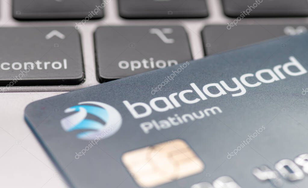 London. UK- 01.29.2023. A Barclaycard Platinum bank card on top of a laptop computer with a person pressing the option button.