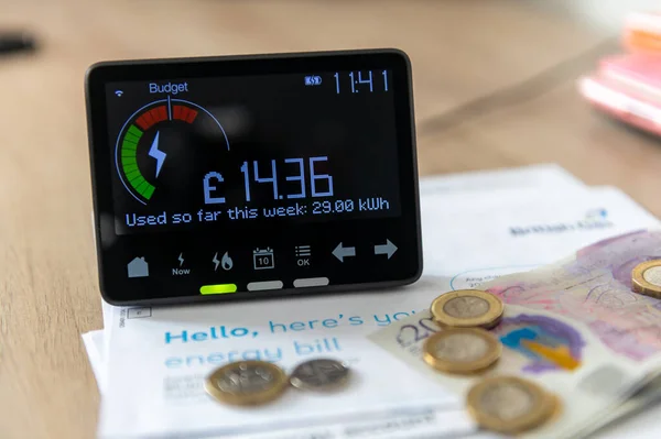 A smart energy meter on household energy bills. Cost of living, rising energy cost concept