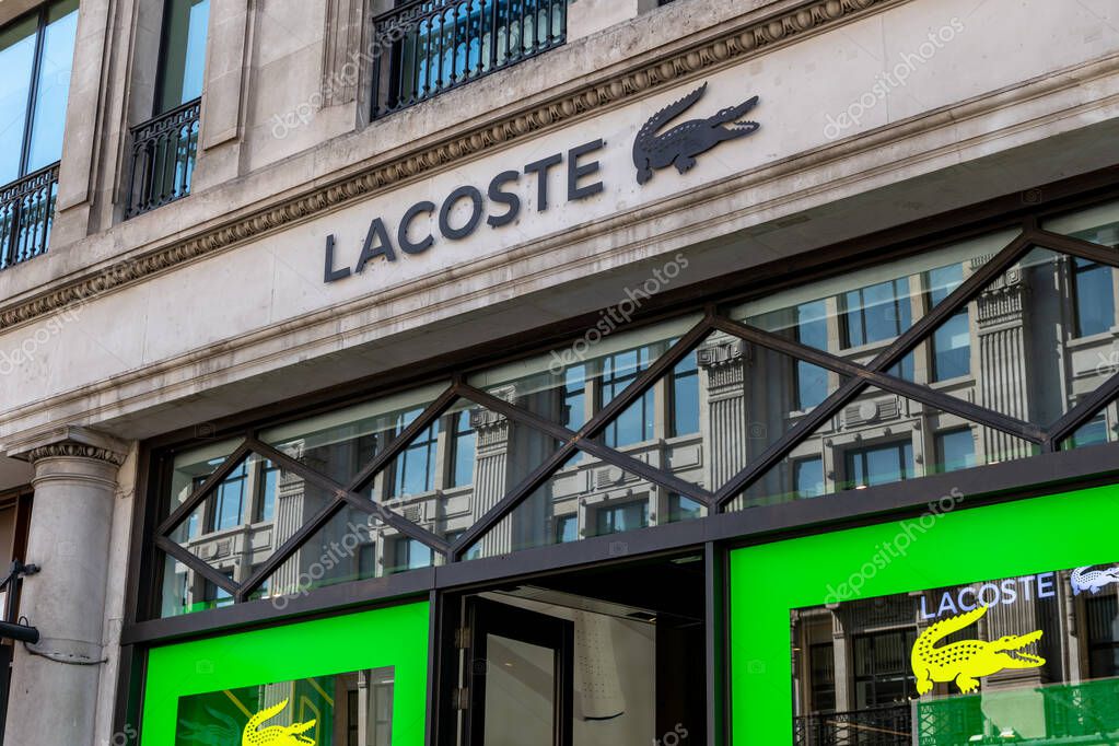 London. UK- 04.09.2023. The name sign and logo of the French luxury brand Lacoste on the facade of its retail store on Regent Street.