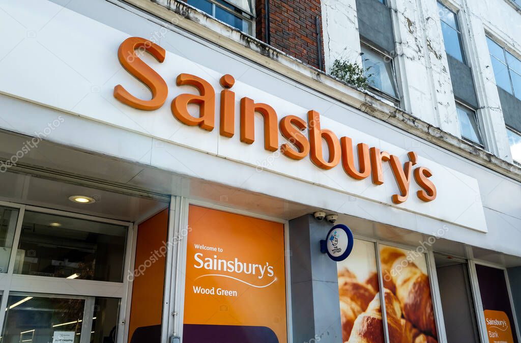 London. UK- 04.12.2023. The company name sign above the entrance of a branch of Sainsbury's grocery supermarket.