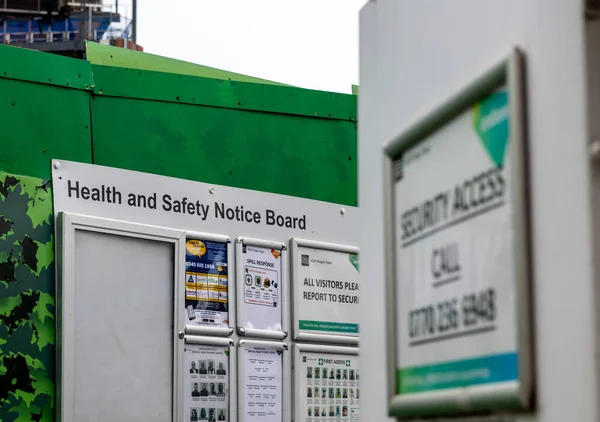 stock image London. UK- 05.04.2023. A health and safety notice board by the entrance to a construction site.