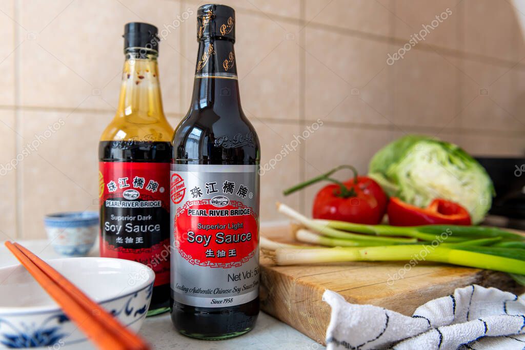 London. UK- 05.14.2023. A bottle of light and dark Pearl River Bridge soy sauce on a kitchen worktop.
