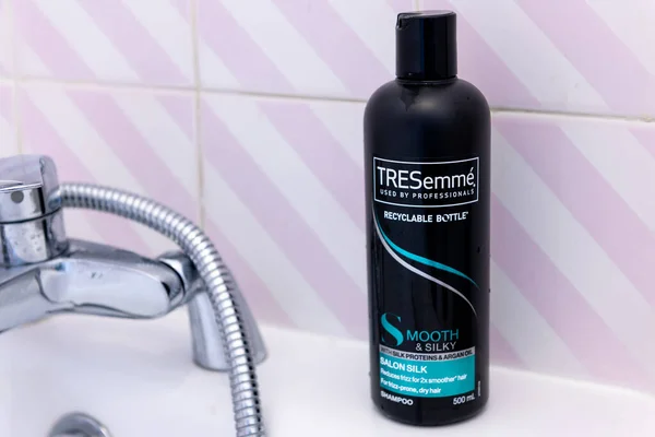 stock image London. UK- 05.21.2023. A bottle of TRESemme shampoo on a bath tub.