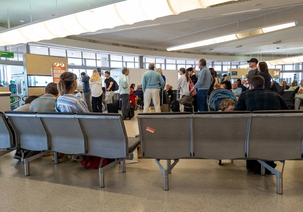 stock image Gatwick airport. UK- -6.07.2023. Passengers waiting by the boarding gate ready to board their flight.