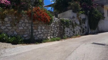 Lefkada adası. Yunanistan - 06.17.2023. Güzel bir çiçek bahçesi olan bir Yunan köy evi..