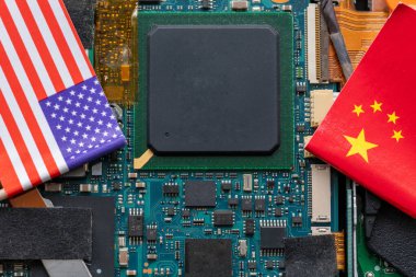 A technology conflict, competition concept with the American and Chinese flags on top of a semiconductor circuit board. clipart
