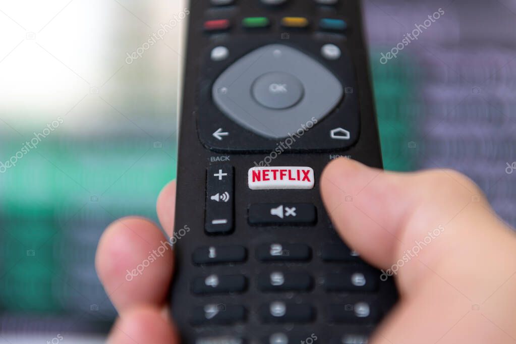 London. UK- 09.13.2023. A person using the remote control to access the popular streaming entertainment service provider Netflix.