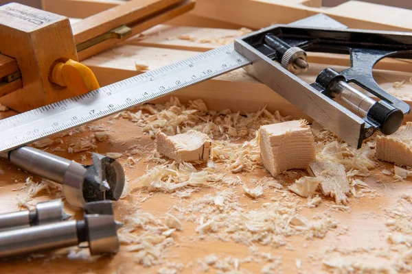 stock image Timber, wood shavings and carpentry tools on a work bench.