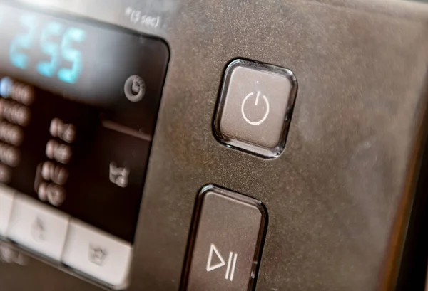 The power on and start button on a domestic appliance.