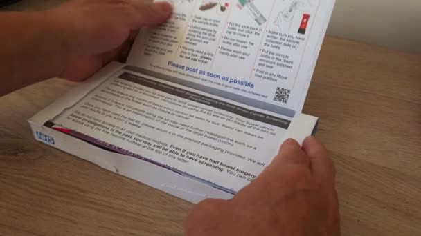 London 2023 Person Unboxing Bowel Cancer Test Kit — Stock Video