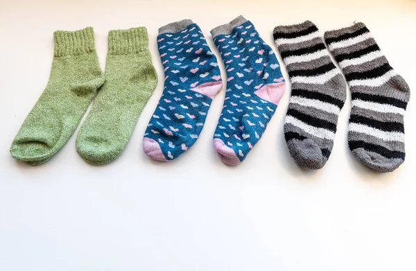 Various thick Winter socks arranged in a row isolated in white.