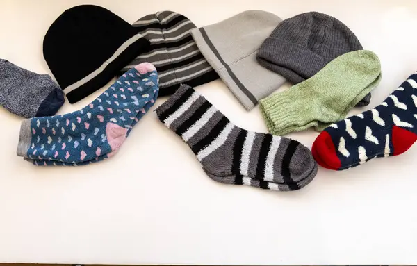 Various woolly hats and thick Winter socks isolated in a white background.