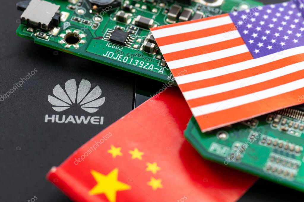 London. UK- 04.26.2024. A technology political economic concept. The logo of the Chinese tech company Huawei, a circuit board and the Chinese and American flag.