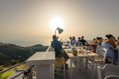 Exanthia, Lefkada, Greece-07.01.2024. The mountainside Rachi restaurant offering customers stunning views and sunsets along with their meals. clipart