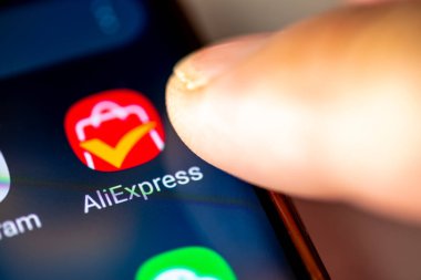 Londra mı? UK- 07.28.2024. Bir Android telefonunun ekranında uygulamayı açan bir parmak ile birlikte çevrimiçi perakende hizmeti uygulaması AliExpress.