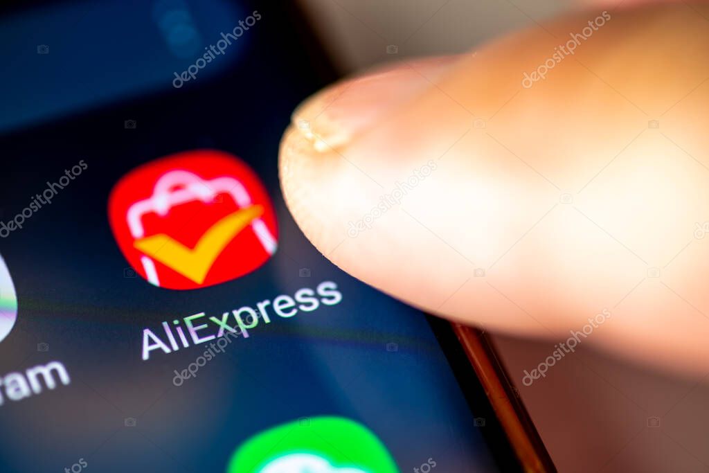 London. UK- 07.28.2024. The online retail service app AliExpress on the screen of an Android phone with a finger opening the application.