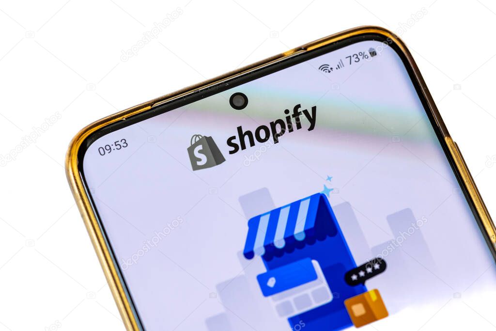 London. UK- 07.28.2024. The home page of the Canadian multinational e-commerce app Shopify, on the screen of a smart phone,isolated in white.