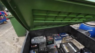 Londra mı? Birleşik Krallık-08.18.2024. Bir geri dönüşüm merkezinde araba aküsünü geri dönüştüren bir kişinin bakış açısı.