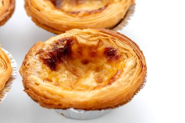 Taze pişmiş yumurtalı tartları kapayın, çıtır çıtır, gevrek hamur işleri beyaz üzerine izole edilmiş..