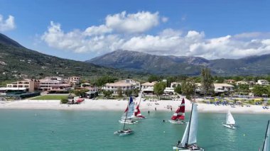 Lefkada, Yunanistan-05.19.2025. Vassiliki Sahili 'ndeki su sporları aktiviteleri ve plaj tesislerinin alçak seviye görüntüsü..