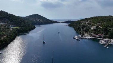 Yunan adası tatil beldesinden denize açılan bir yat. Hava klipsi.