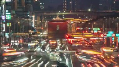 Cityscape of Taipei, the vibrant capital city of Taiwan, with light trails of busy traffic dashing before the historical site 