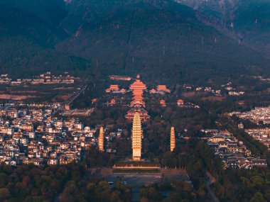 Old Town of Dali with Three Pagodas during the sunset time. Chongsheng Temple and Cangshan Mountains