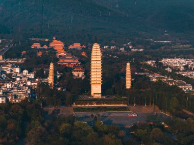 Old Town of Dali with Three Pagodas during the sunset time. Chongsheng Temple and Cangshan Mountains