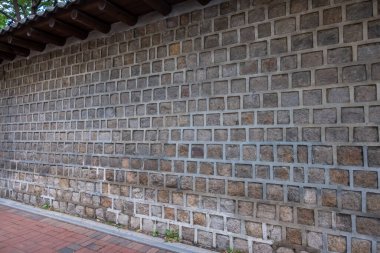 Traditional Korean stone wall boundary with roof