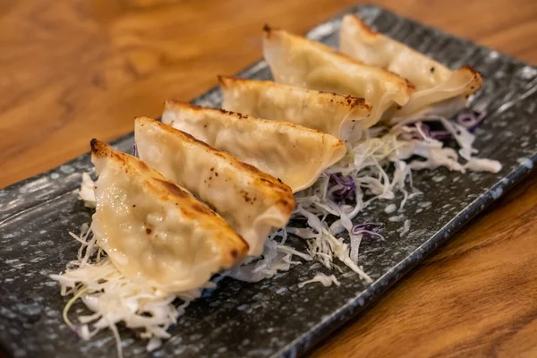 stock image Gyoza served on a plate with vegetable on the table