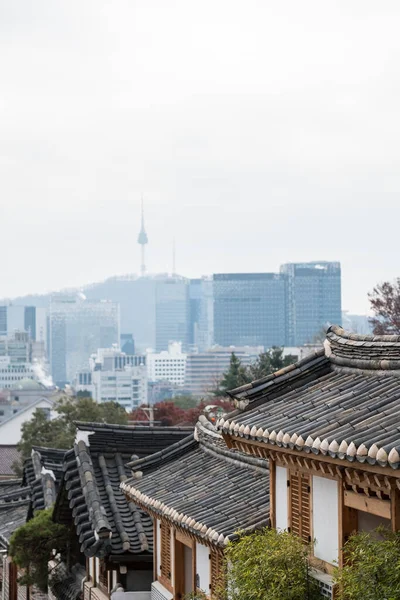 stock image Bukchon Hanok Village, a Korean traditional village with N Seoul Tower in Seoul, South Korea.