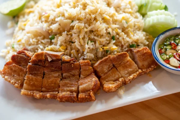 Fried rice with crispy pork served on plate