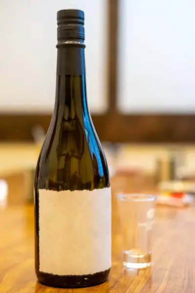 A bottle of Sake, a Japanese rice wine with glass on the table