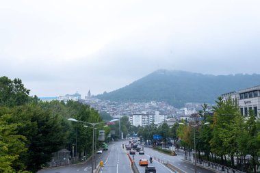 Seoul, South Korea - 3 September 2023: View of N Seoul Tower disappeared in the cloud from Noksapyeong Bridge, one of the famous locations from Korean drama called Itaewon Class clipart