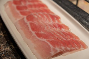 Sıcak tencere için dilimlenmiş çiğ domuz eti yakın plan.