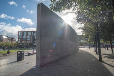 Manchester, England - 5 October 2017: People walking in Piccadilly Gardens, a green space in Manchester city centre, with concrete structure by Tadao Ando clipart