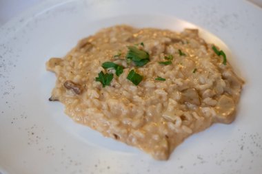 Risotto tabakta servis edilir. Popüler bir İtalyan pilav yemeği..