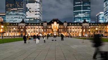 Tokyo, Japan - Nov 28, 2022: Night timelapse of Japanese people, Asia traveler walk at Tokyo Station building. Train transportation, Asia travel tourism landmark, tourist attraction or Asian city life