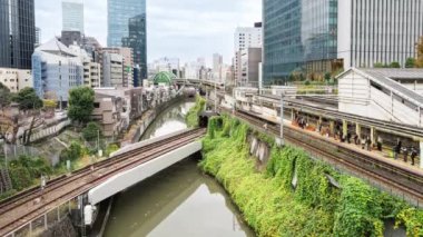 Japon metro treninin tren raylarından geçişi Tokyo 'daki istasyon platformunda yolcu alımı. Asya taşımacılığı şehir hayatı, Asyalılar banliyö ulaşımı kavramı