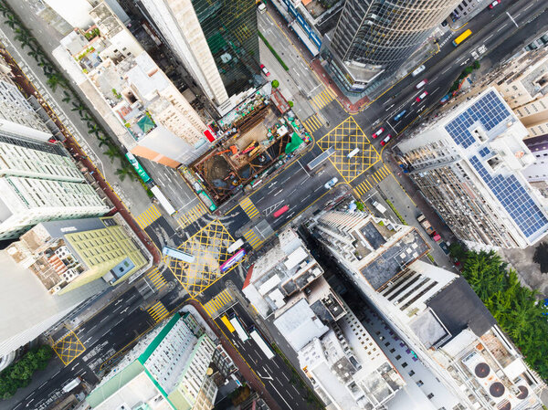 Car traffic on road junction intersection in Hong Kong city downtown. Drone aerial top view. Asian people lifestyle, Asia city life or public transportation concept