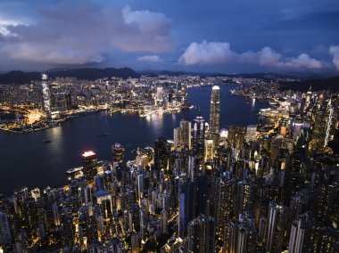 Cityscape night view of Hong Kong island, drone aerial high angle view. Skyscraper buildings in financial district, ship transportation on Victoria harbour. Asia tourism travel, tourist landmark clipart