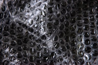 The texture of the packaging air-bubble film on a blue background in full screen